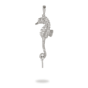 A silver seahorse with white stones hanging from it's tail.