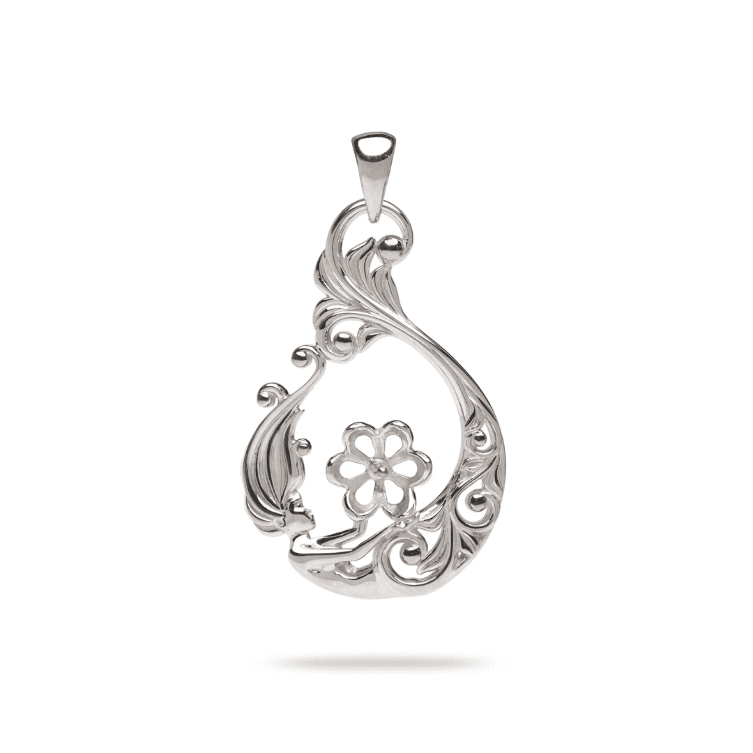 A silver pendant with a flower on it.