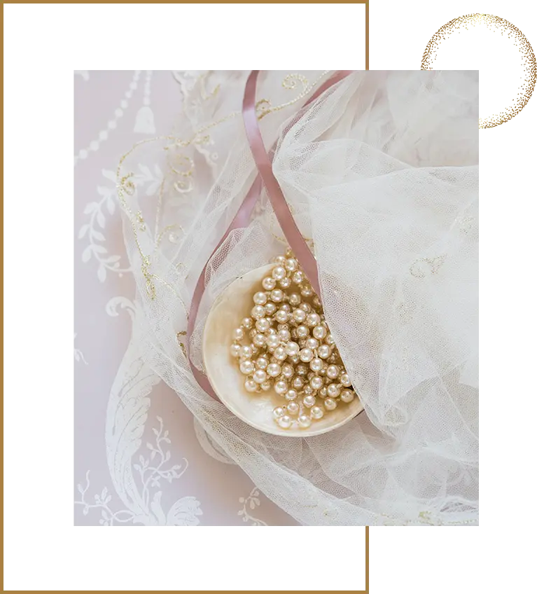 A wooden spoon with pearls on top of it.